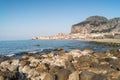 Idyllic view of Cefalu from the long sandy beach. Cathedral and Rocca di Cefalu rocky mountain on a sunny day in Cefalu, Sicily,