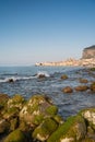 Idyllic view of Cefalu from the long sandy beach. Cathedral and Rocca di Cefalu rocky mountain on a sunny day in Cefalu, Sicily, Royalty Free Stock Photo