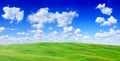 Idyllic view, green hills and blue sky with white clouds Royalty Free Stock Photo