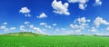 Idyllic view, green hills and blue sky with white clouds Royalty Free Stock Photo