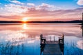 Idyllic view of the long pier with wooden bench on the lake. Sunset or sunrise over the water