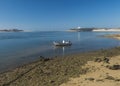 Idyllic view of the mouth of Mira river flowing into the Atlantic Ocean with small anchored fishing boat. Vila Nova de Royalty Free Stock Photo