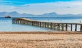 Wooden jetty pier at bay of Alcudia on Majorca island, Spain Royalty Free Stock Photo