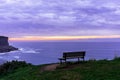 Idyllic view of a sea from the cliff with a bench under a cloudy sky - perfect for wallpaper Royalty Free Stock Photo