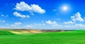 Idyllic view, sun shining over green rolling fields Royalty Free Stock Photo