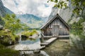 Idyllic view of traditional old wooden boat house at scenic Lake Obersee Royalty Free Stock Photo