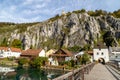 Idyllic view at the village Essing in Bavaria, Germany with the Altmuehl river, high rocks in background and a wooden bridge in Royalty Free Stock Photo