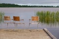 Idyllic view of the wooden pier in the lake with chairs for negotiations Royalty Free Stock Photo