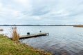 Idyllic view of a wooden pier in a lake with a cloud sky Royalty Free Stock Photo