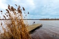 Idyllic view of a wooden pier in a lake with a cloud sky Royalty Free Stock Photo