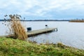 Idyllic view of a wooden pier in a lake with a cloud sky Royalty Free Stock Photo