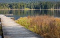 Idyllic view of a wooden pier in the lake with mountain scenery background in cloudy morning Royalty Free Stock Photo