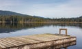 Idyllic view of a wooden pier in the lake with mountain scenery background in cloudy morning Royalty Free Stock Photo