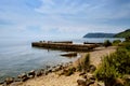 Idyllic view of the wooden pier in the lake with mountain scenery background. Lake Baikal in the day Royalty Free Stock Photo