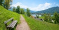 Idyllic viewpoint Leeberg hill, above lake tegernsee, recreational area with bench and flower meadow, at springtime. landscape Royalty Free Stock Photo