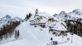 Idyllic village on top of hill in winter. Ski resort, skiing, tourism. Monte Lussari, Italy.