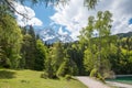 idyllic walkway around lake Eibsee, bavaria, with view to Zugspitze mountain at springtime Royalty Free Stock Photo
