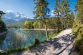 idyllic walkway lakeside Eibsee, bavaria, with view to Zugspitze mountain at springtime Royalty Free Stock Photo