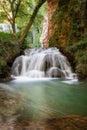 Idyllic Waterfall in rainforest landscape. Water flowing in tranquil scenery. Royalty Free Stock Photo