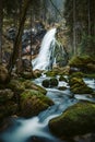 Idyllic waterfall scene with mossy rocks in the forest