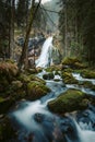 Idyllic waterfall scene with mossy rocks in the forest