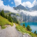 idylliic hiking trail above lake Oeschinensee, famous tourist destination Kandersteg, switzerland landscape