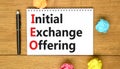 IEO initial exchange offering symbol. Concept words IEO initial exchange offering on beautiful note. Beautiful wooden table