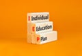IEP individual education plan symbol. Concept words IEP individual education plan on wooden blocks on beautiful orange background