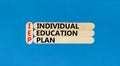 IEP individual education plan symbol. Concept words IEP individual education plan on wooden sticks on beautiful blue table blue