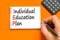 IEP individual education plan symbol. Concept words IEP individual education plan on white note on a beautiful orange background.