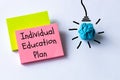 IEP Individual Education Plan symbol. IEP individual education plan word concept on colorful cards, white background. Bulb icon.