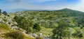 iew from the summit of Mount Pantokrator on a mountain valley with an access road to the summit