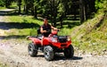 Iezer Mountains - Romania - 2019. Young people having a fun ride in the forest of Iezer Mountains on a ATV Royalty Free Stock Photo