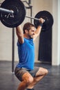 If it aint hurting, it aint working. a handsome young man lifting weights while working out in the gym. Royalty Free Stock Photo