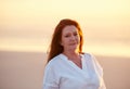 If anybody needs me, Ill be at the beach. mature woman standing on the beach at sunset. Royalty Free Stock Photo