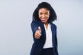 If it brings you success go for it. Studio shot of an attractive young businesswoman giving thumbs up against a grey Royalty Free Stock Photo