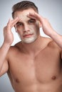 If it burns, youre doing it wrong. Studio portrait of an attractive young man applying a beauty treatment to his face