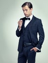 If confidence was currency, hed be even wealthier. A studio portrait of a dapper young man smoking.