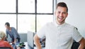 If I stay positive my team stays positive. Portrait of a confident young businessman working in a modern office with his Royalty Free Stock Photo