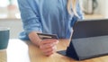 If its a bargain then what are you waiting for. a woman holding her credit card while browsing on her digital tablet. Royalty Free Stock Photo