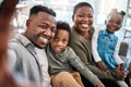 If my family is smiling, Ive won. a happy young family taking selfies on the sofa at home. Royalty Free Stock Photo