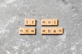 If not now when word written on wood block. If not now when text on cement table for your desing, Top view concept Royalty Free Stock Photo