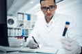 If the patient doesnt know, their blood will. a young scientist conducting medical research on blood in a laboratory.