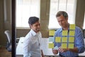 If we remove this element, it all falls into place. two businessmen preparing for a presentation by using adhesive notes