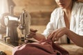 If you can not buy clothes sew one. Cropped shot of female making garment on sewing machine, creating new dress in