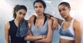 If you cant beat them, join them. Portrait of three young sportswomen standing and posing in the gym.
