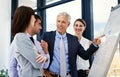 And if you could draw your attention to this.... Shot of a businessman giving a presentation to colleagues in an office.