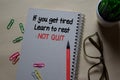 If you get tired. Learn to rest NOT QUIT write on a book isolated on Office Desk Royalty Free Stock Photo