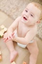 If you happy and you know it, clap your hands. A cute little boy clapping his hands with his blocks lying next to him. Royalty Free Stock Photo