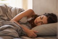 If only you knew what I dream about.... A beautiful young woman sleeping in her bed. Royalty Free Stock Photo